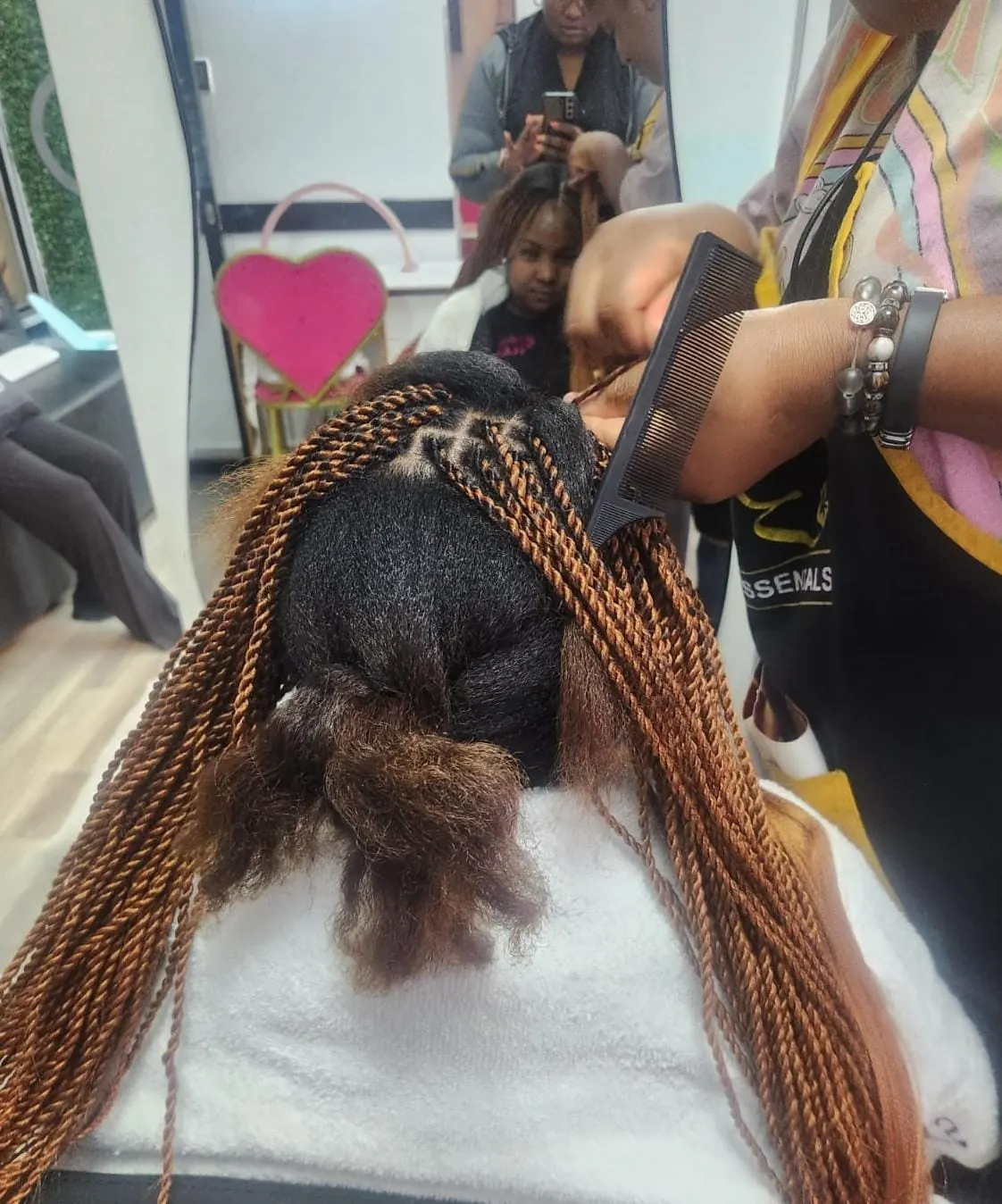 Before and after copper knotless braids with space buns at Beauty by Haks — before