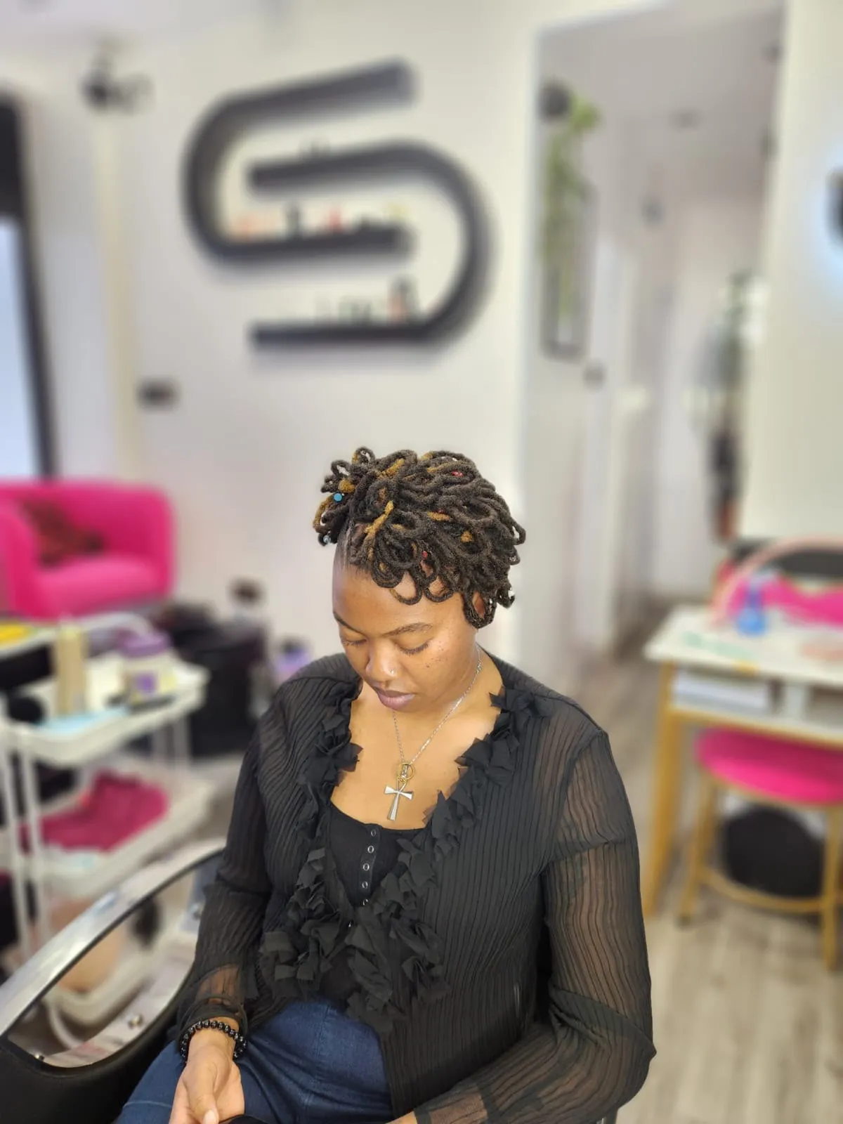 Finished loc hairstyle with beads in the salon