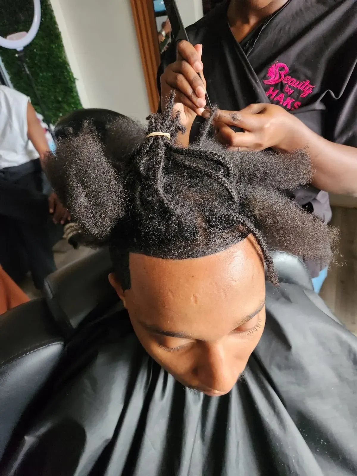 Dreadlock retouch in progress at the salon