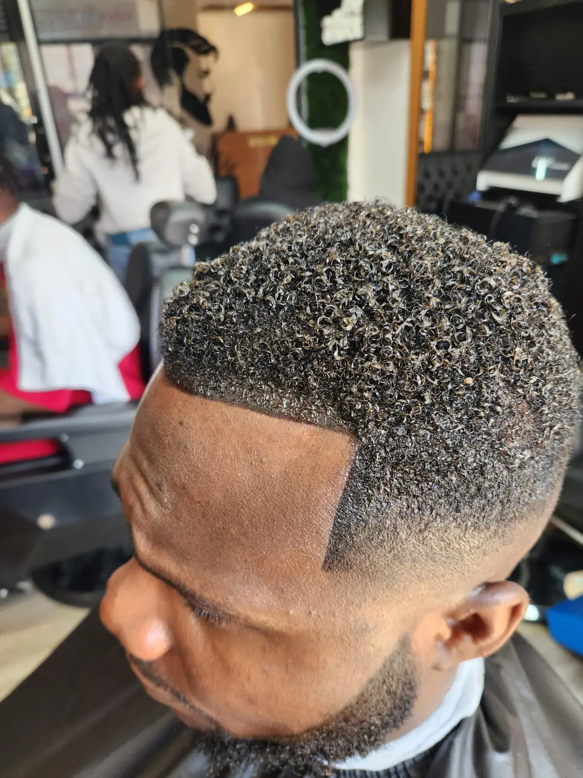 Men's textured crop haircut with a sharp fade