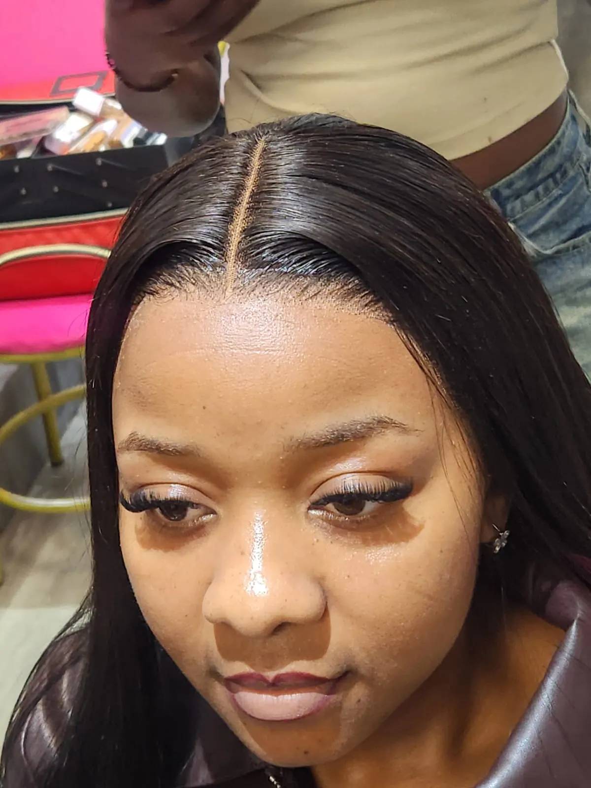 Lace wig installation with a clean middle part at Beauty by Haks